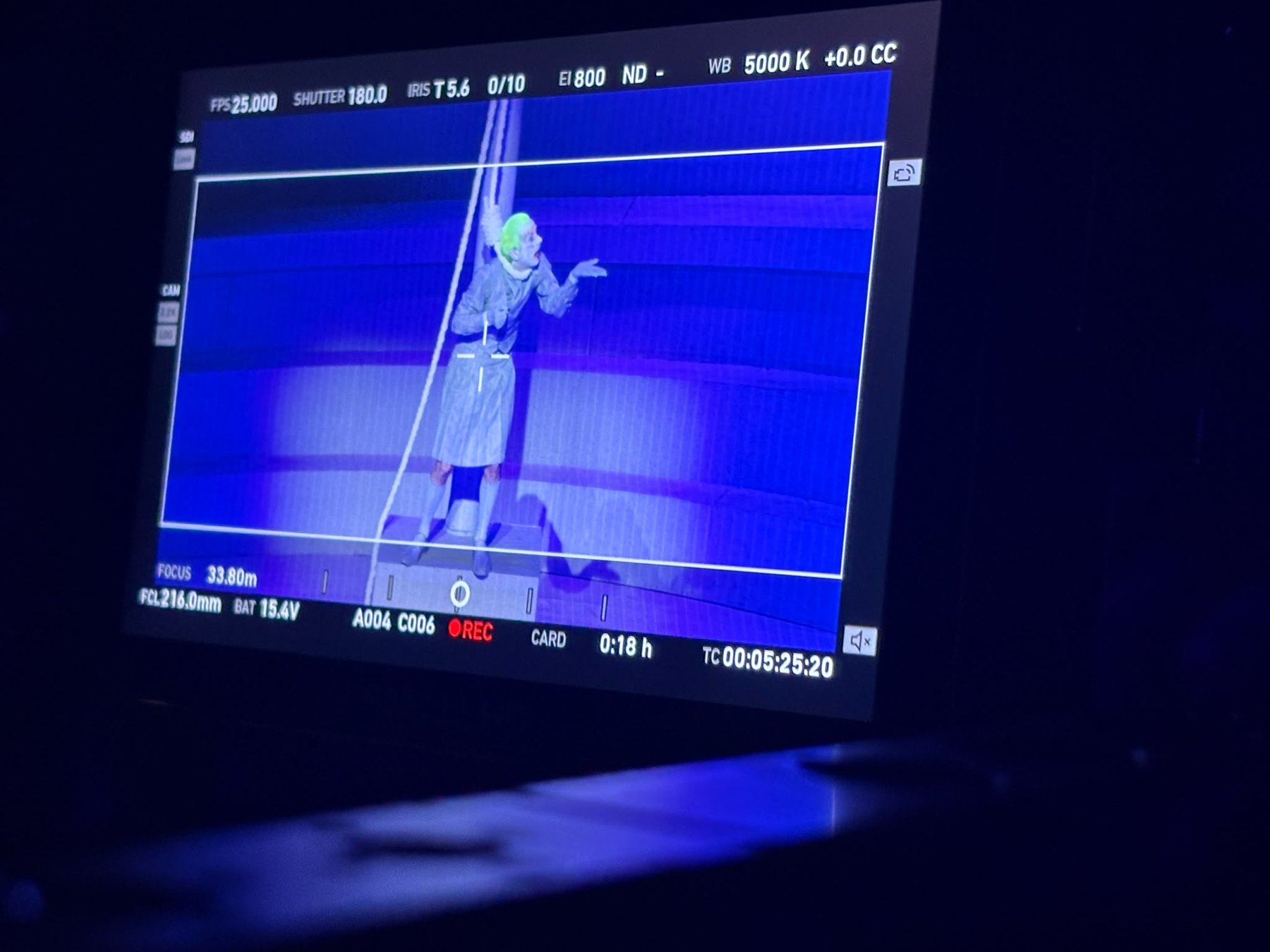 Camera monitor showing a performer in blue light